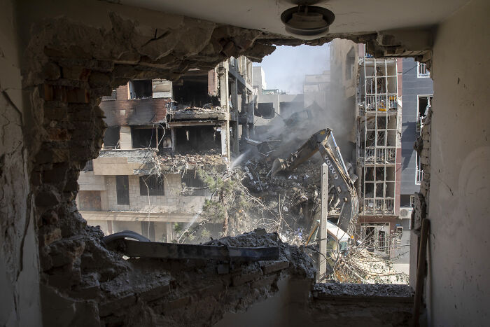 View of destroyed buildings and rubble after missile strike near Iran State TV, showing aftermath of Israeli missile attack.