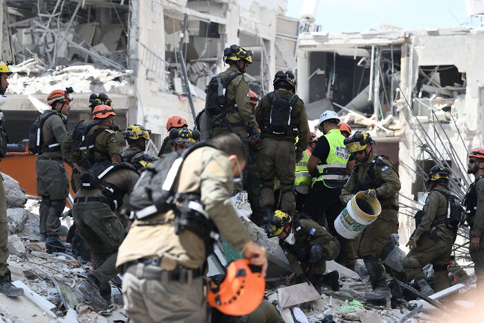 Rescue workers search through rubble after missile strike in Iran killing girl who fled Ukraine war for cancer treatment