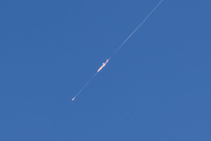 Missile launched against clear blue sky symbolizing Iran vows retaliation for U.S. nuclear strikes concerns.