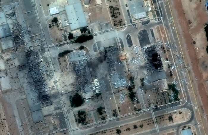 Aerial view of damaged structures showing early signs of destruction from U.S. Iran strikes with doubts on success raised.