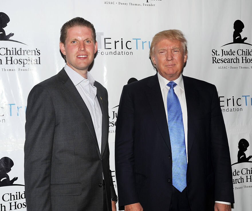 Two men in suits at a charity event, related to Trump Organization unveiling $499 gold phones for real Americans.