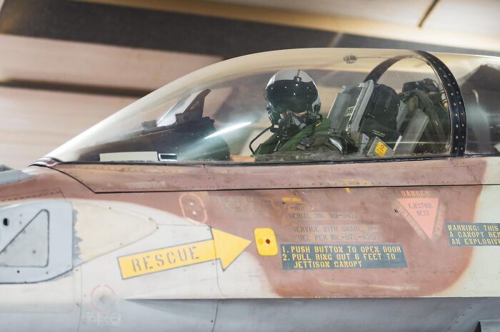 Pilot seated inside a military jet preparing for flight amid tensions with Iran firing drones at Israel in recent strikes.