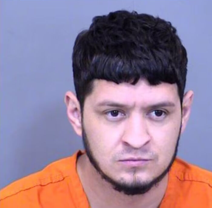 Mugshot of a man in an orange prison uniform related to a tragic incident involving a girl fatally shot by her brother.