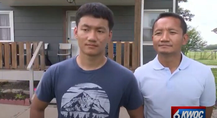 Two men standing outside a house during police rescue of children from Bible study camp amid abuse investigation.