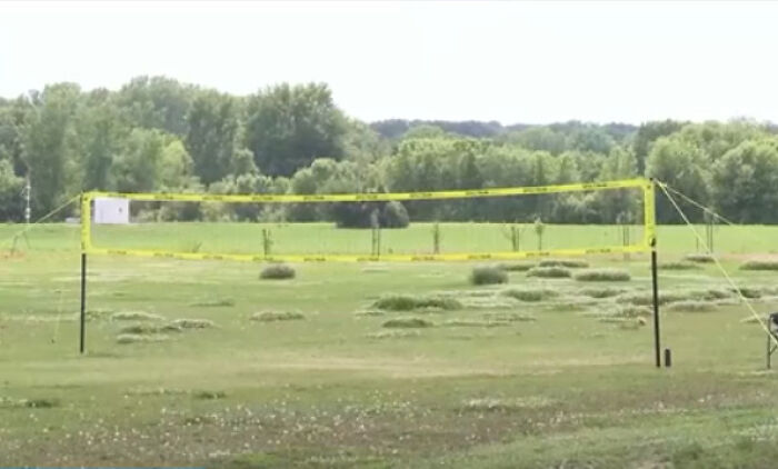 Police tape cordons off an outdoor area at a Bible study camp during abuse and human trafficking investigation.