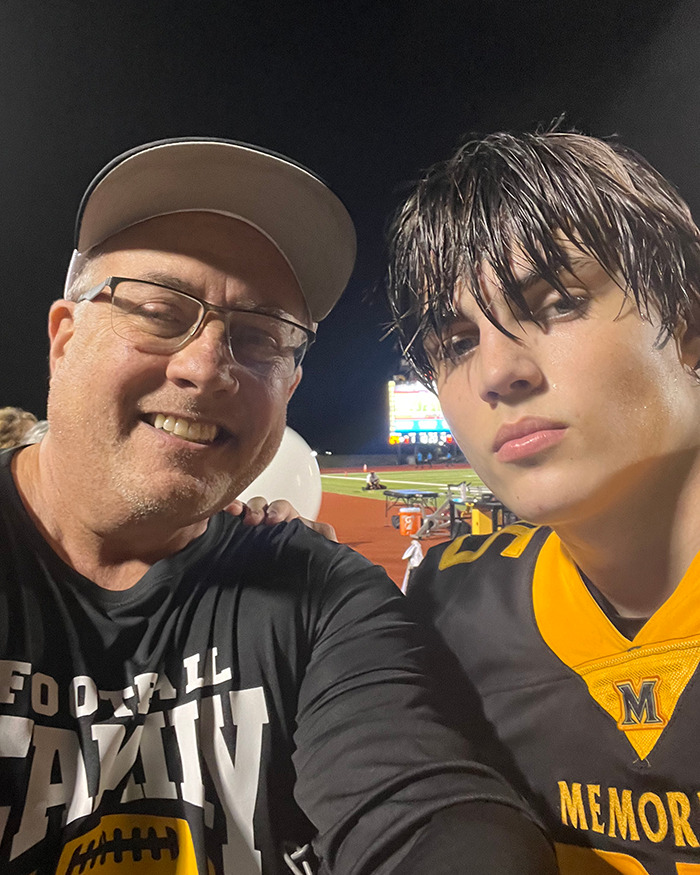 Karmelo Anthony, 17, wearing football jersey with man in cap at night sports event, related to track meet stabbing case.