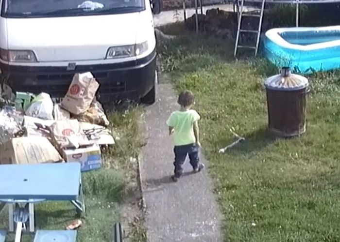 Toddler walking alone in yard with clutter and a small pool, highlighting concerns of abuse and neglect.