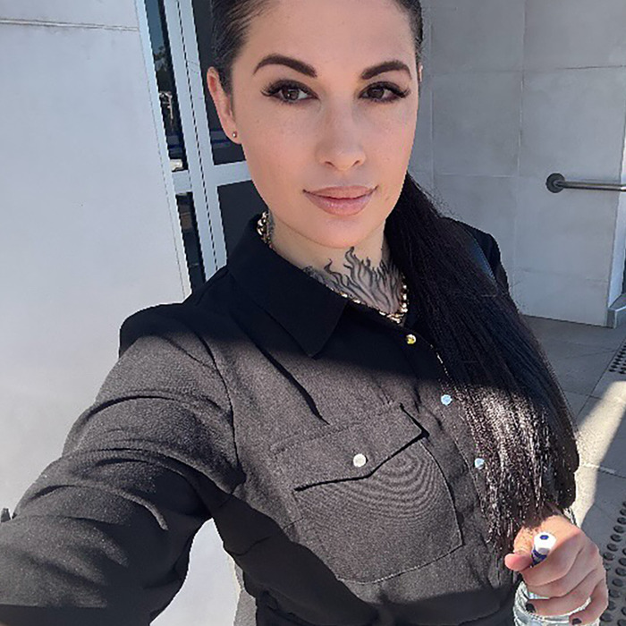 Young woman outdoors wearing a black shirt with a tattoo on her neck, related to Aussie mom accused of murdering daughter news.