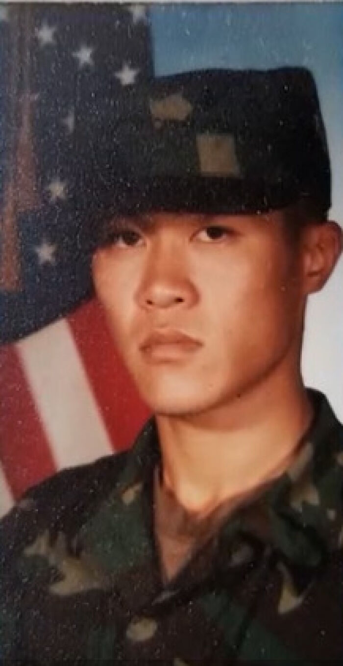 Portrait of a Purple Heart veteran in military uniform with an American flag in the background, highlighting ICE self-deportation.