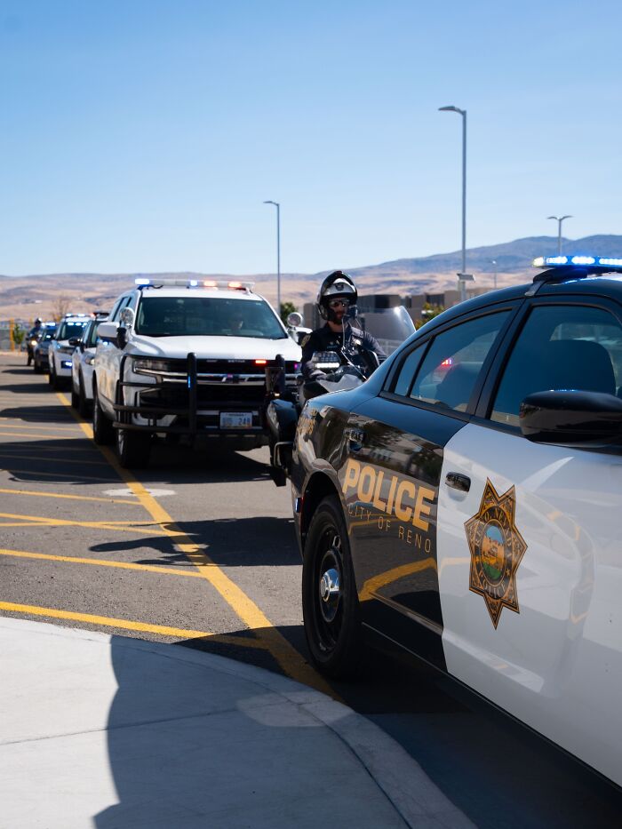 Police vehicles and officers in Reno, Nevada, responding to an incident involving a Nevada teacher accused of abuse.