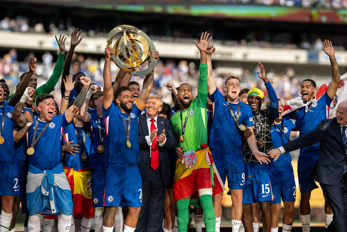 Winning team celebrating with FIFA Gold Club World Cup trophy after receiving a replica due to Trump's hold on the original trophy.