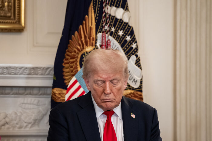 Former president sitting with head bowed in formal setting symbolizing 2024 presidential election impact on young Americans&rsquo; mental health