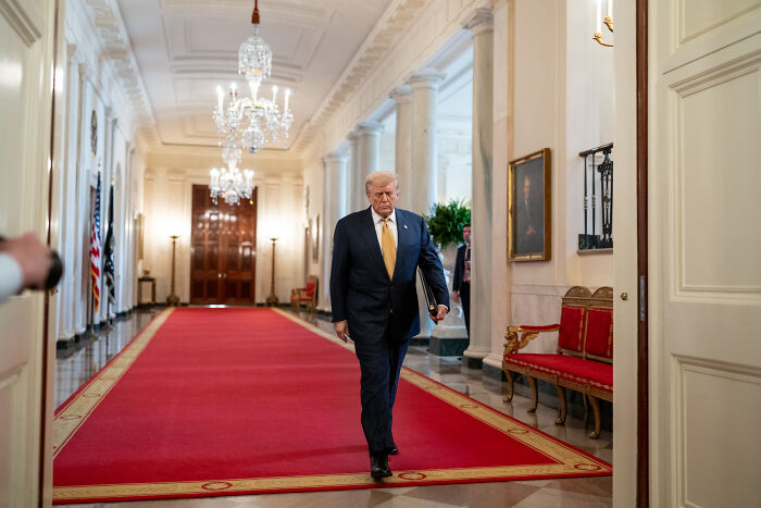 Former President walking in a hallway, symbolizing concerns over ICE access to Medicaid records and medical data politicization.