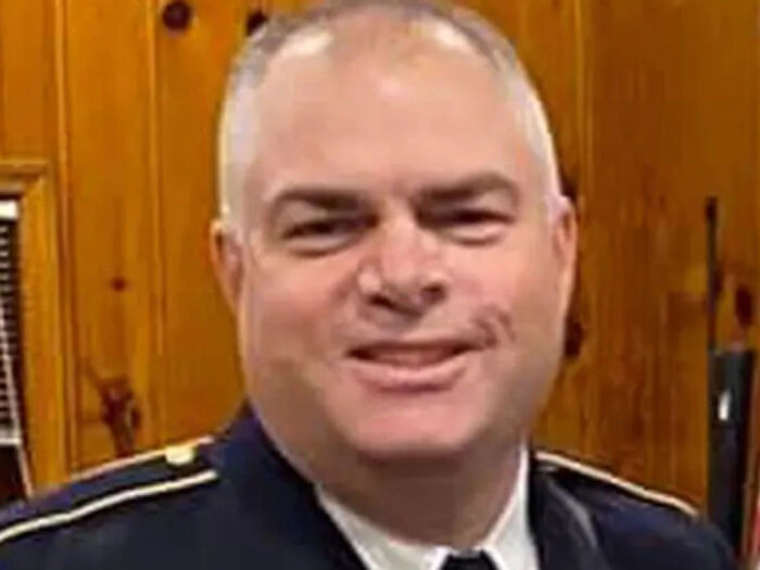NJ police chief in uniform smiling, related to accusations of ritualistic abuse and prolonged assault in court papers.
