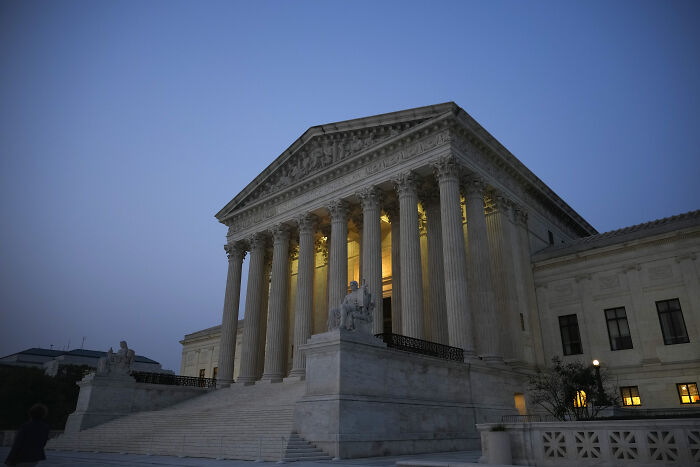 U.S. Supreme Court building at dusk, symbolizing legal aspects of Barron Trump&rsquo;s U.S. citizenship debate.