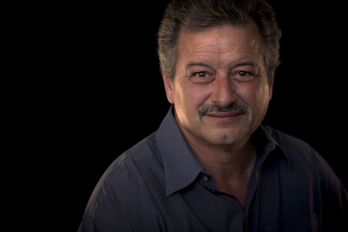 Survivor who escaped Jonestown, the site known for drinking the Kool-Aid, pictured against a dark background.