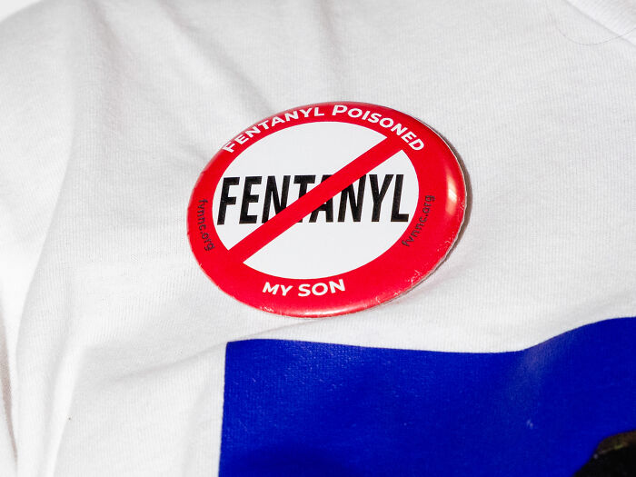Red and white anti-fentanyl pin on a white shirt symbolizing efforts to address America's overdose crisis.
