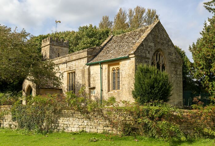 Stone church building with trees and greenery, illustrating Ellen DeGeneres and Portia de Rossi reaction after Trump win.