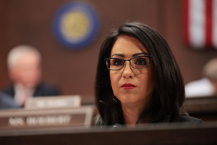 Congresswoman Lauren Boebert wearing glasses and dark hair, addressing issues related to her son&rsquo;s child abuse citation.
