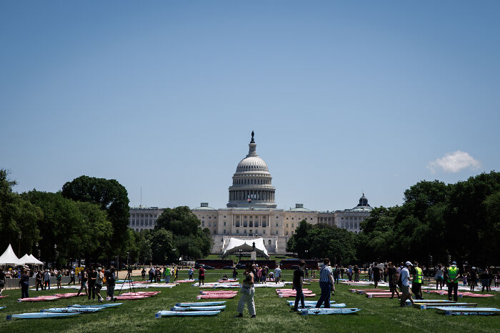 US Capitol building with people gathered on the lawn, relating to DOJ subpoenas for doctors providing care to trans minors