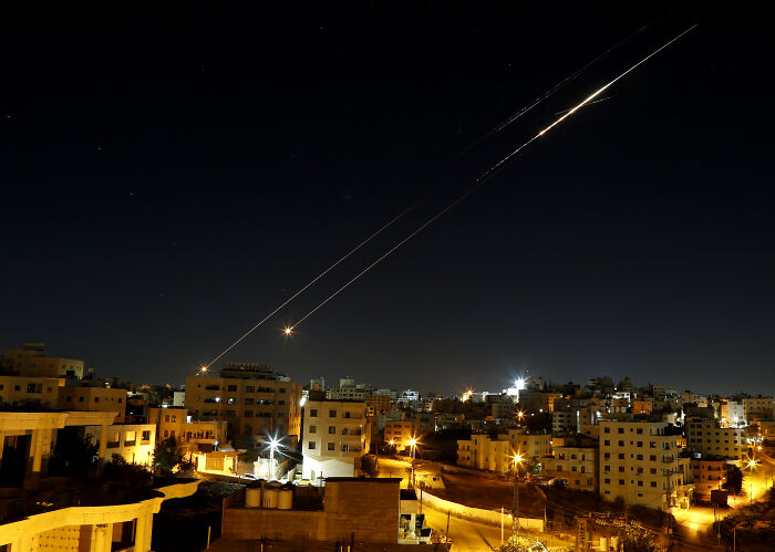 Night sky over city with bright trails from missiles, illustrating Netanyahu Trump Nobel Peace Prize nomination context.