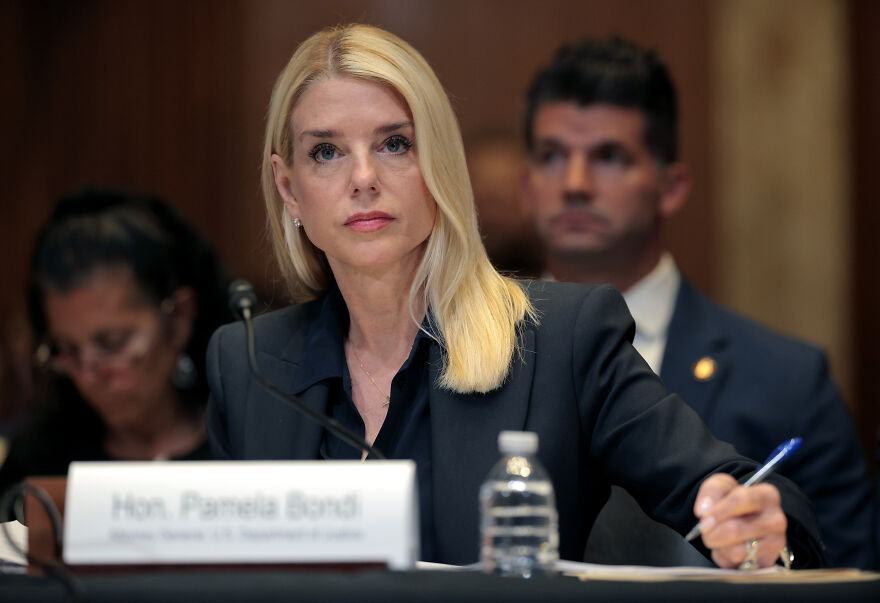 A woman with blonde hair in a black blazer at a congressional hearing discussing Epstein files and Republican blockage.