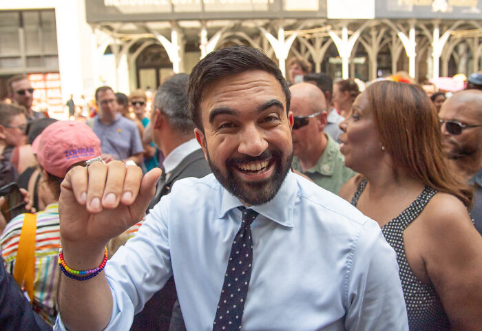 Zohran Mamdani smiling in a crowd, highlighting SAT scores amid Columbia African American application controversy.