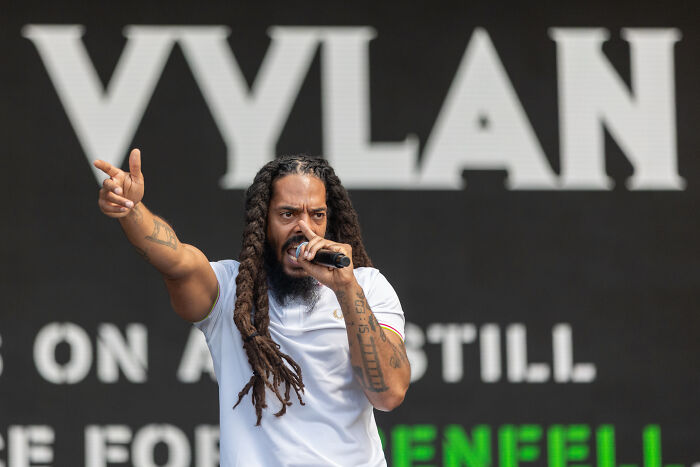 Bob Vylan performing onstage with microphone, State Department blocks rap duo from entering the U.S. after controversial chant.