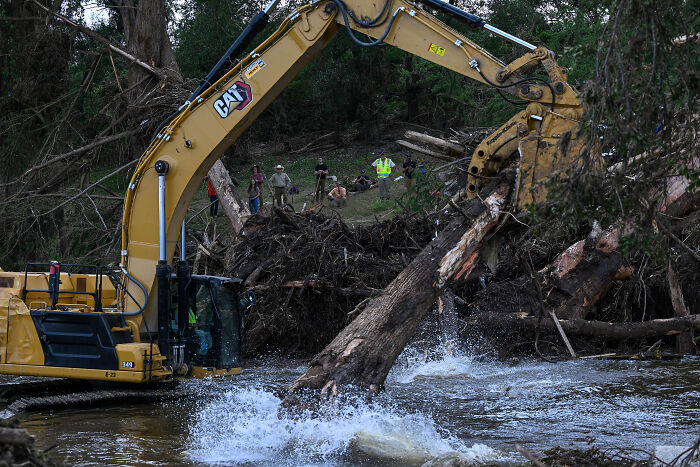 Excavator removing flood debris from river as aid delays impact Texas flood response efforts, sources claim.