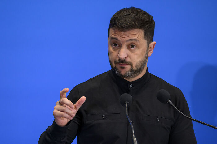 Volodymyr Zelenskyy speaking at a podium, addressing the reversal of controversial anti-corruption agency law.