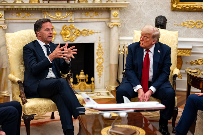 Donald Trump and another man in a formal meeting discussing Ukraine arms and Trump&rsquo;s stance on Putin&rsquo;s involvement.