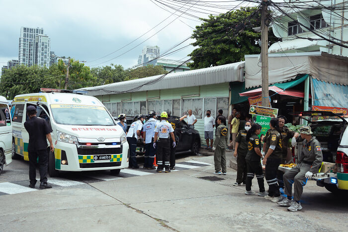 Emergency responders and police gathered at a Bangkok food market after a mass shooting incident with multiple casualties.