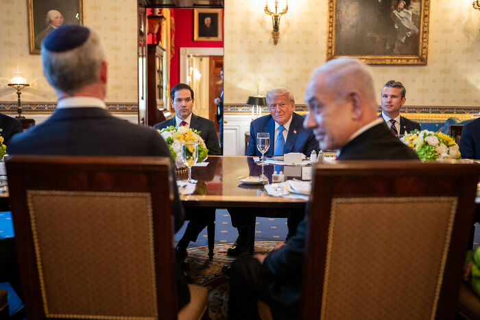 Donald Trump and Israeli leaders in a formal meeting room discussing Netanyahu's surprise Nobel Peace Prize nomination.