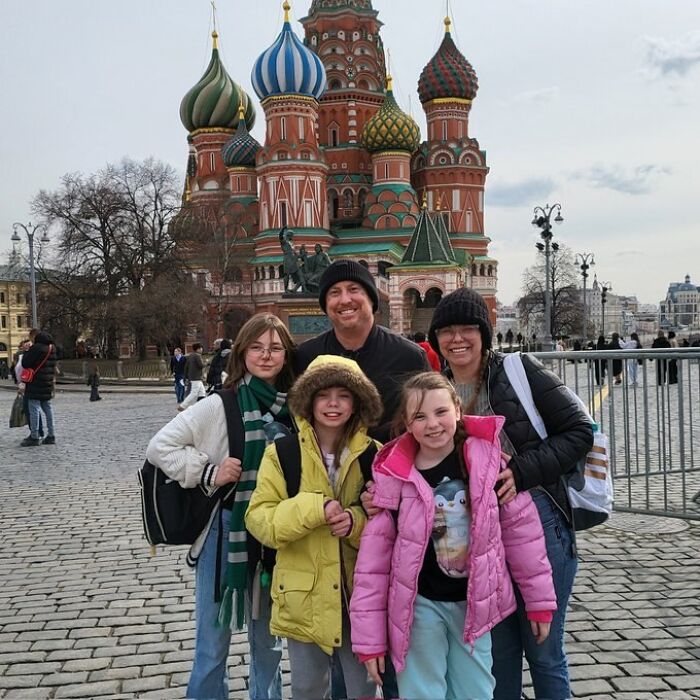Family of five in winter coats posing in front of Saint Basil&rsquo;s Cathedral, related to dad-of-three sent to front lines in Ukraine war.