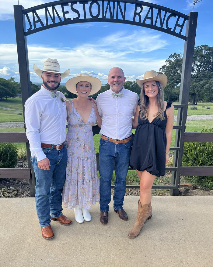 Family posing under Jamestown Ranch sign, capturing a moment before Texas floods with dad leaving soul-crushing voicemails to children.