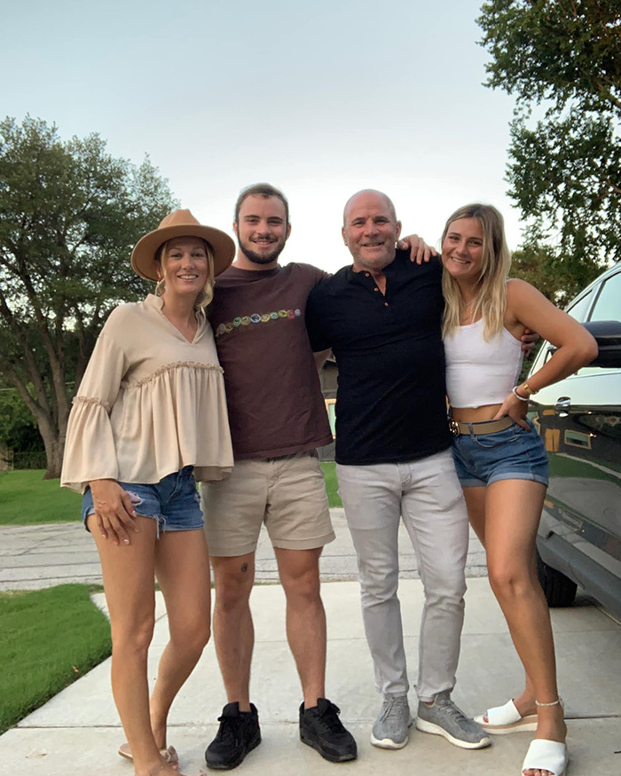 Family posing outdoors smiling together, representing dad left children soul-crushing voicemails before Texas floods tragedy.