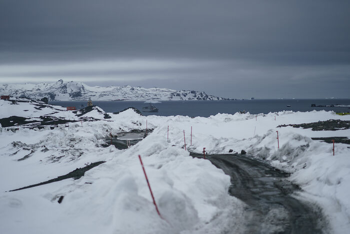 Snow-covered road and icy landscape in Antarctica where a US teen was held during a solo flight supporting a cancer cause.