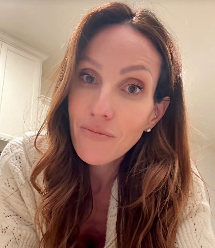 Close-up of a woman with long hair wearing a white sweater, discussing a pro-life Republican accused in abortion payments.