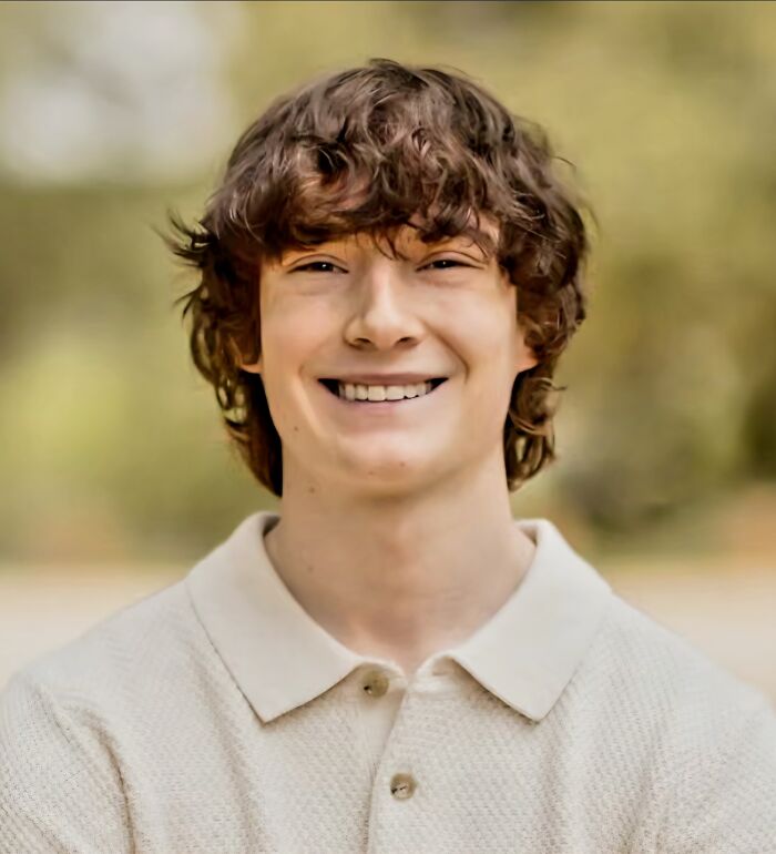 Teen smiling outdoors with blurred background, highlighting dangers of relying on AI therapists in youth mental health discussions.