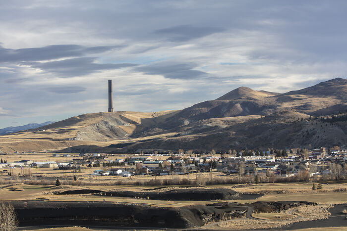 Montana landscape with hills and town in foreground as manhunt for bar shooting suspect continues in the area