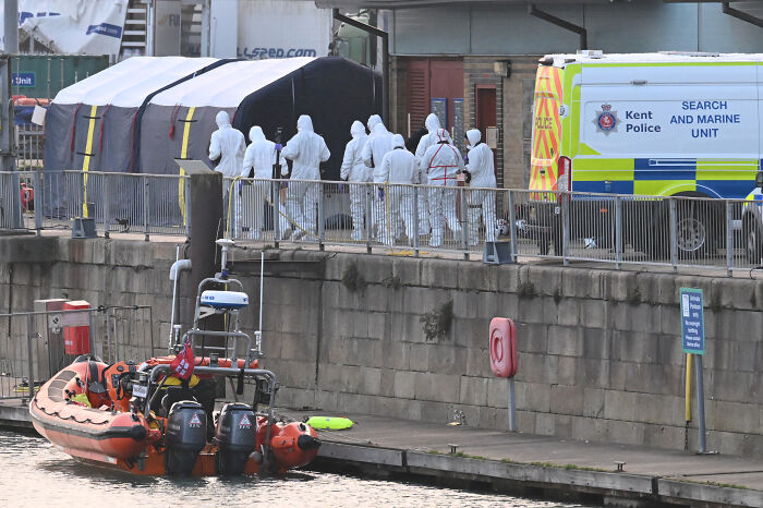 French cops and UK marine police at port in protective suits near boat involved in clash with dad and son trying to board vessel
