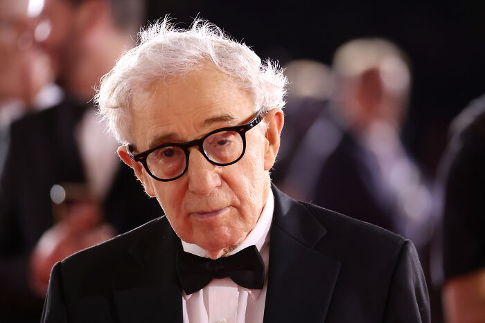 Woody Allen wearing black tuxedo and glasses at a formal event, igniting fury in Ukraine after Moscow Film Week appearance