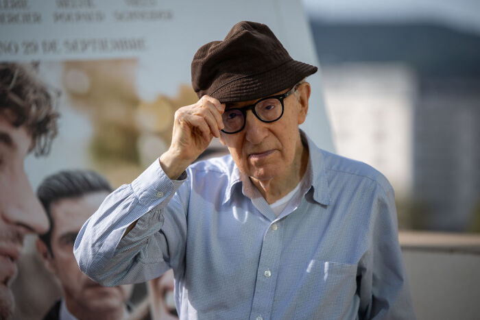 Woody Allen wearing a hat and glasses outdoors, sparking controversy in Ukraine after Moscow Film Week appearance