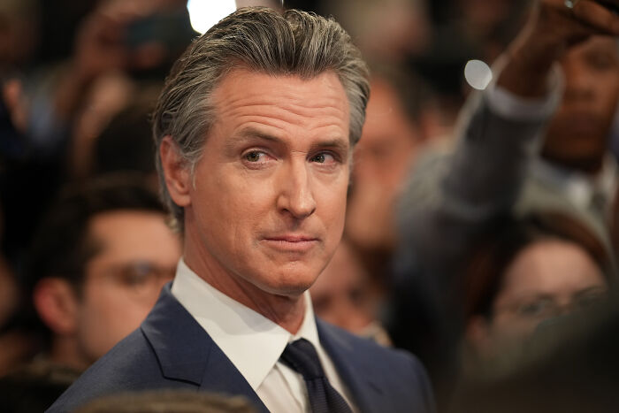 California Governor Gavin Newsom in a suit attending a public event, related to California redistricting plan discussions.