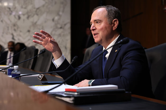 Senator Adam Schiff speaking at a hearing, dressed in a dark suit and blue tie, addressing mortgage fraud investigation.