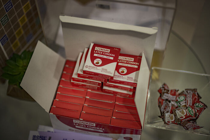 Boxes of latex condoms displayed on a counter, highlighting access issues related to women&rsquo;s reproductive rights and health cuts.