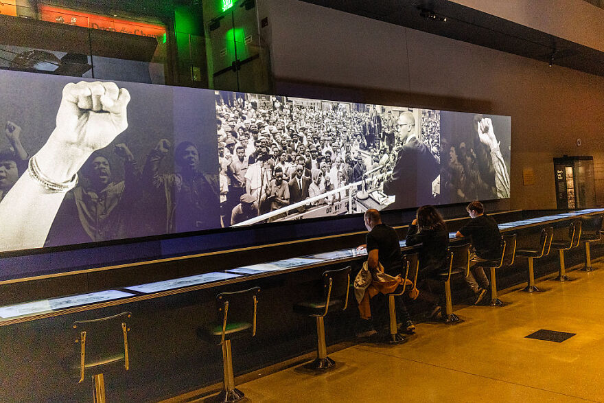Visitors at the Smithsonian museum viewing a historic civil rights exhibit during a review of U.S. history and culture.