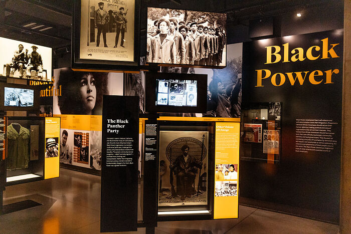Exhibit on Black Power and Black Panther Party at Smithsonian Museum with historic photos and artifacts on display.
