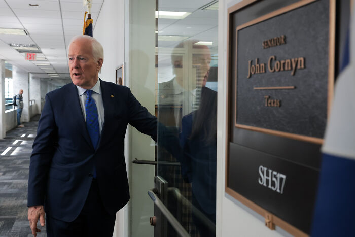 Texas senator entering office near nameplate, relating to FBI&rsquo;s legal right question amid redistricting standoff.