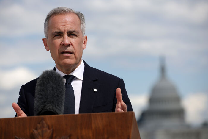 Senior official speaking at a podium about major countries suddenly recognizing Palestine with a blurred Capitol building in background.